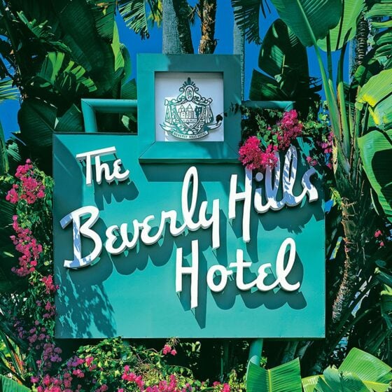 The Beverly Hills Hotel sign with flowers and banana plant