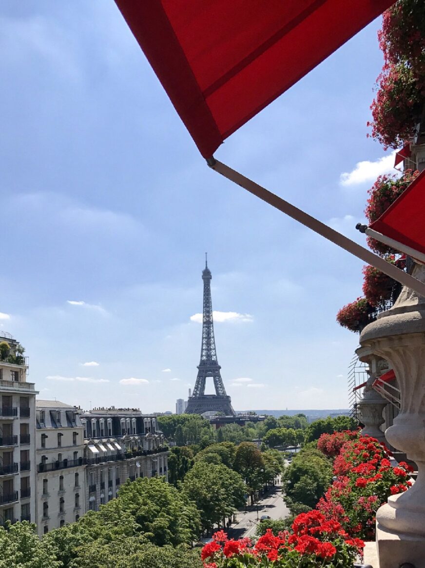 Facade of Hotel Plaza Athenee with Eiffel Tower background
